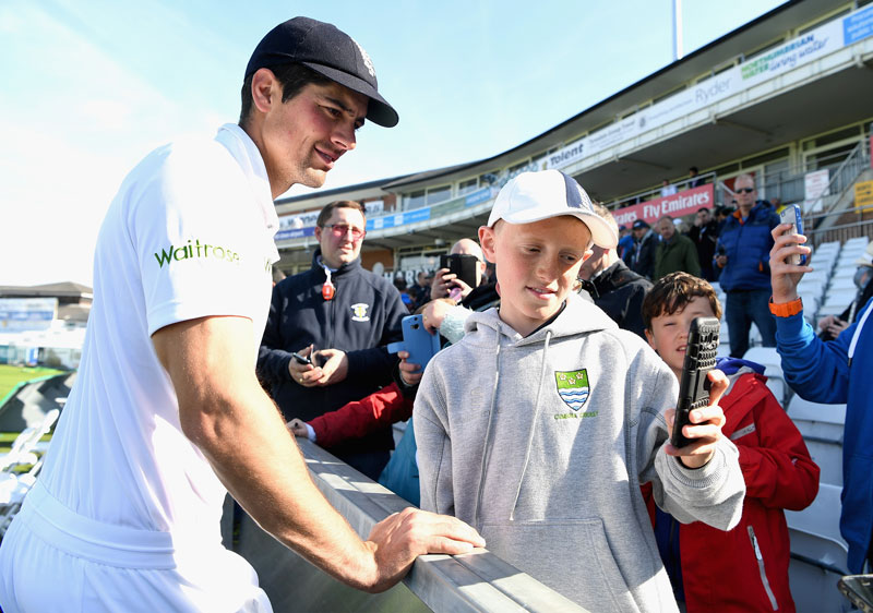 Alastair Cook posing for a selfie with a fan